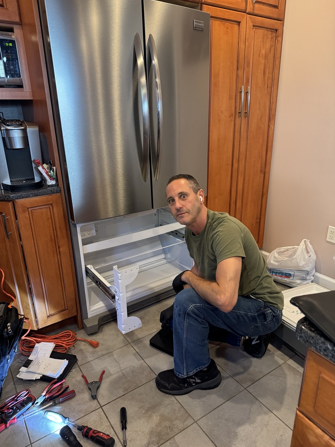 Jeff working on a refrigerator in a customer's kitchen